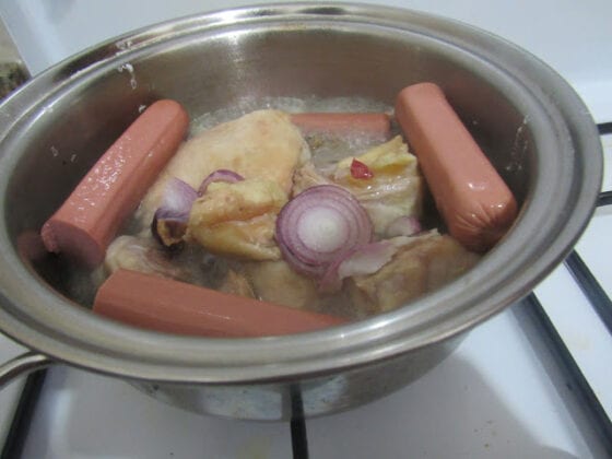 boiling chicken and sausages for shawarma